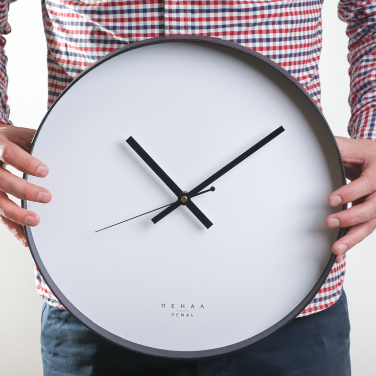 Black and White - large, modern wall clock, close up view from the hand